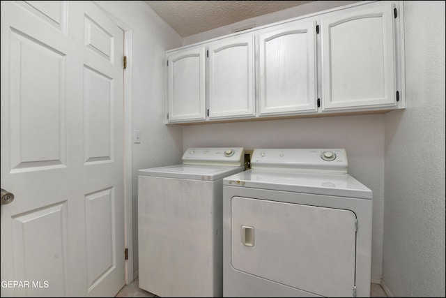 4372 Loma De Oro Dr, El Paso, TX 79934 - laundry area with cabinet space, washer and clothes dryer, and a textured wall