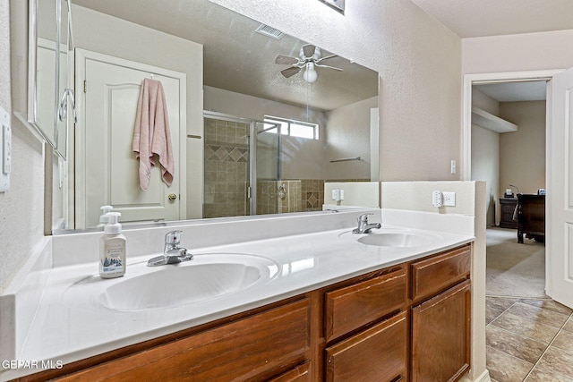 14181 Rudy Valdez Dr, El Paso, TX 79938 - full bathroom with a shower stall, double vanity, a ceiling fan, and tile patterned flooring