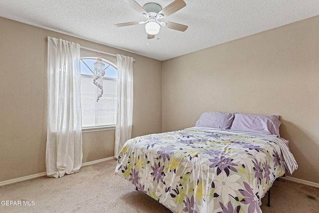 14181 Rudy Valdez Dr, El Paso, TX 79938 - bedroom featuring carpet flooring, baseboards, a ceiling fan, and a textured ceiling