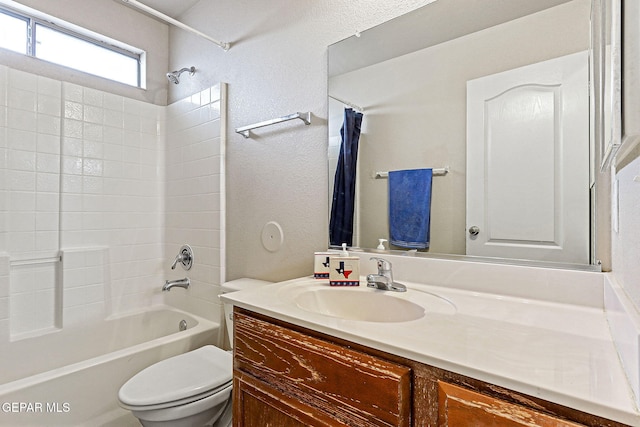 14181 Rudy Valdez Dr, El Paso, TX 79938 - full bath with a textured wall, toilet, vanity, and shower / bathtub combination with curtain