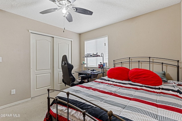 14181 Rudy Valdez Dr, El Paso, TX 79938 - bedroom with light colored carpet, a closet, a textured ceiling, ceiling fan, and baseboards