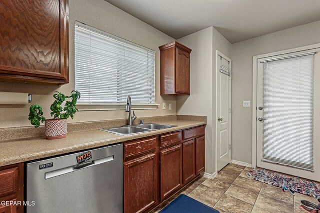14181 Rudy Valdez Dr, El Paso, TX 79938 - kitchen with stainless steel dishwasher, a sink, and baseboards