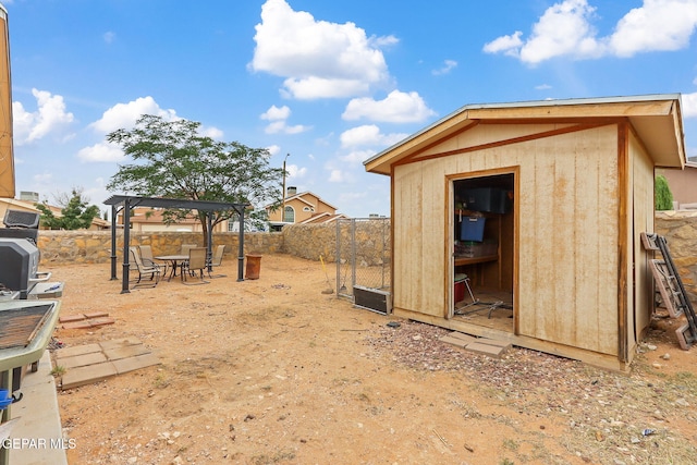14181 Rudy Valdez Dr, El Paso, TX 79938 - fenced backyard with a storage shed, a gazebo, and an outdoor structure