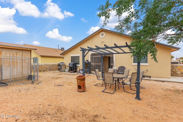 14181 Rudy Valdez Dr, El Paso, TX 79938 - rear view of property with a pergola, stucco siding, fence, and a patio