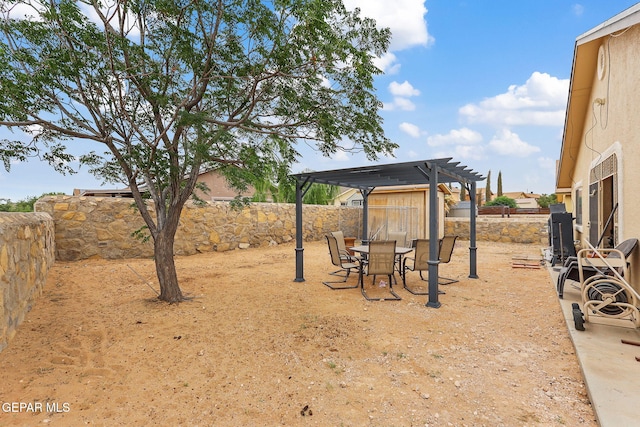 14181 Rudy Valdez Dr, El Paso, TX 79938 - fenced backyard with a pergola and outdoor dining area