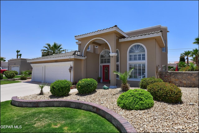 1337 Emerald Gate Ln, El Paso, TX 79936 - mediterranean / spanish-style home with stucco siding, concrete driveway, an attached garage, and a tiled roof