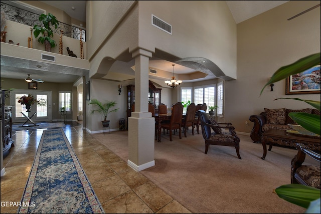 1337 Emerald Gate Ln, El Paso, TX 79936 - foyer with a chandelier, high vaulted ceiling, baseboards, ornate columns, and carpet floors