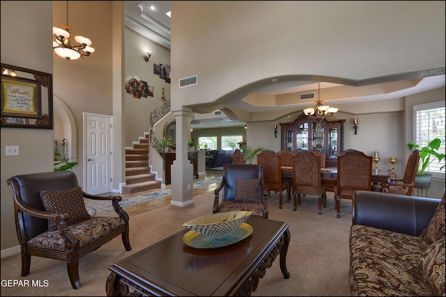 1337 Emerald Gate Ln, El Paso, TX 79936 - carpeted living area with a chandelier, ornate columns, stairs, baseboards, and arched walkways