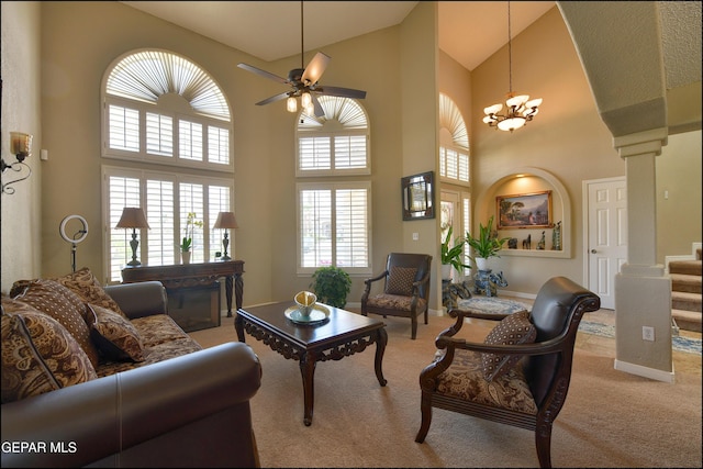 1337 Emerald Gate Ln, El Paso, TX 79936 - living room with light carpet, high vaulted ceiling, ornate columns, a ceiling fan, and a chandelier