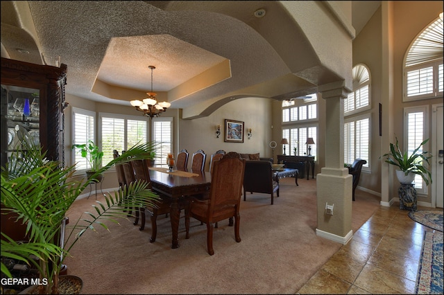 1337 Emerald Gate Ln, El Paso, TX 79936 - dining area featuring a chandelier, healthy amount of natural light, baseboards, arched walkways, and a textured ceiling
