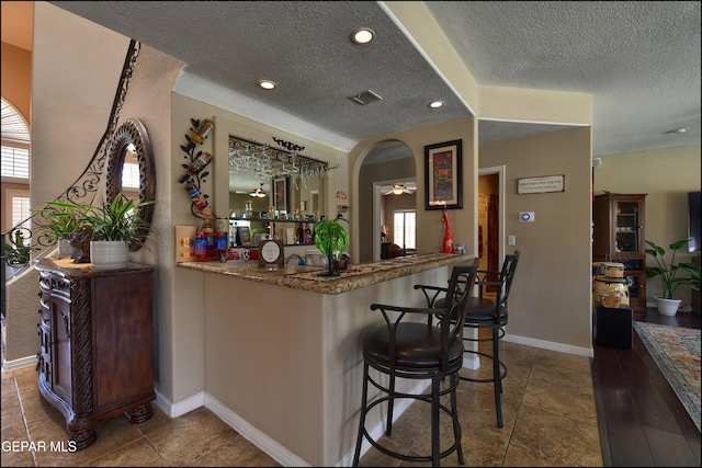 1337 Emerald Gate Ln, El Paso, TX 79936 - indoor wet bar with a textured ceiling, baseboards, a ceiling fan, recessed lighting, and tile patterned floors