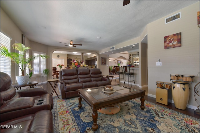 1337 Emerald Gate Ln, El Paso, TX 79936 - living area featuring arched walkways, a ceiling fan, baseboards, and a textured ceiling