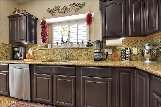 1337 Emerald Gate Ln, El Paso, TX 79936 - kitchen featuring tasteful backsplash, dark brown cabinetry, dishwasher, a sink, and light stone counters