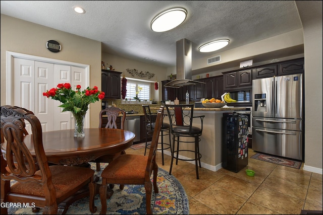 1337 Emerald Gate Ln, El Paso, TX 79936 - dining space with a textured ceiling, light tile patterned flooring, and baseboards
