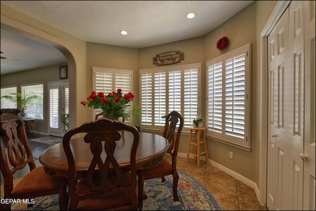 1337 Emerald Gate Ln, El Paso, TX 79936 - dining space featuring arched walkways, baseboards, recessed lighting, and light tile patterned floors