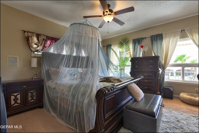 1337 Emerald Gate Ln, El Paso, TX 79936 - bedroom featuring light colored carpet, a textured ceiling, and ceiling fan