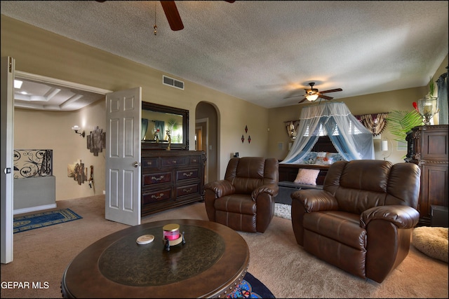 1337 Emerald Gate Ln, El Paso, TX 79936 - living area with ceiling fan, carpet floors, arched walkways, and a textured ceiling