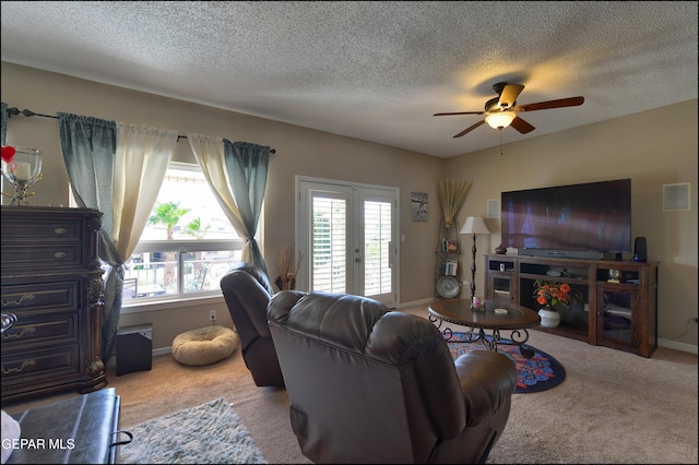 1337 Emerald Gate Ln, El Paso, TX 79936 - carpeted living room featuring ceiling fan, baseboards, and a textured ceiling