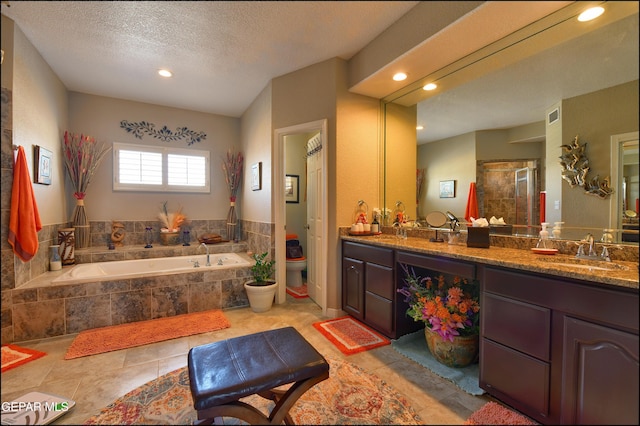 1337 Emerald Gate Ln, El Paso, TX 79936 - full bath featuring double vanity, a bath, recessed lighting, a stall shower, and toilet