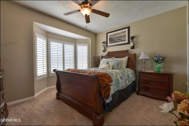 1337 Emerald Gate Ln, El Paso, TX 79936 - carpeted bedroom with a textured ceiling, baseboards, and a ceiling fan