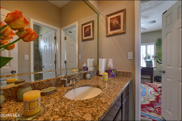 1337 Emerald Gate Ln, El Paso, TX 79936 - bathroom with a textured wall, vanity, and a textured ceiling