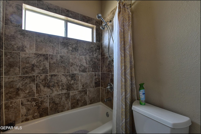 1337 Emerald Gate Ln, El Paso, TX 79936 - bathroom featuring shower / bath combination with curtain, toilet, plenty of natural light, and a textured wall