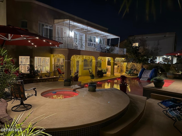 1337 Emerald Gate Ln, El Paso, TX 79936 - patio at twilight featuring a balcony, a patio, and an in-ground hot tub