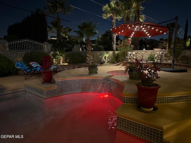 1337 Emerald Gate Ln, El Paso, TX 79936 - pool at night with a patio