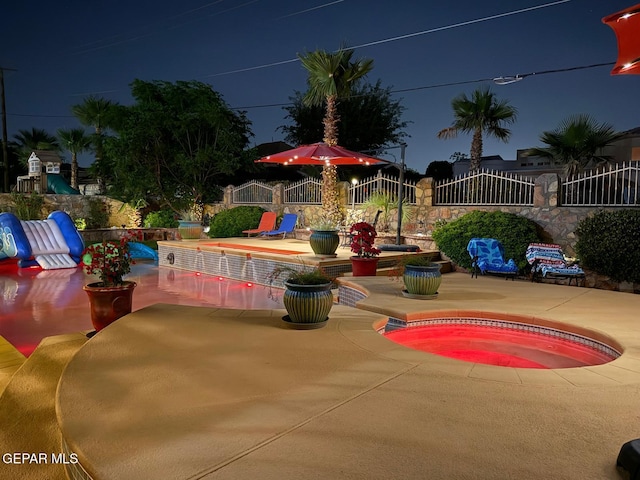 1337 Emerald Gate Ln, El Paso, TX 79936 - pool at twilight featuring a patio and a jacuzzi