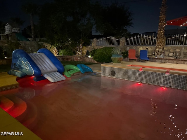 1337 Emerald Gate Ln, El Paso, TX 79936 - pool at twilight featuring a patio area