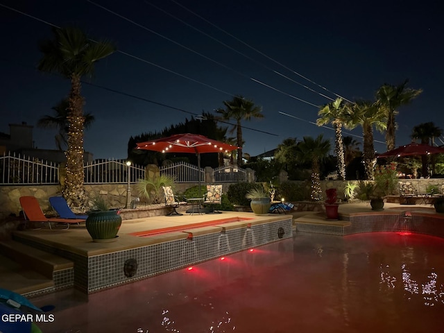 1337 Emerald Gate Ln, El Paso, TX 79936 - pool at night with a patio