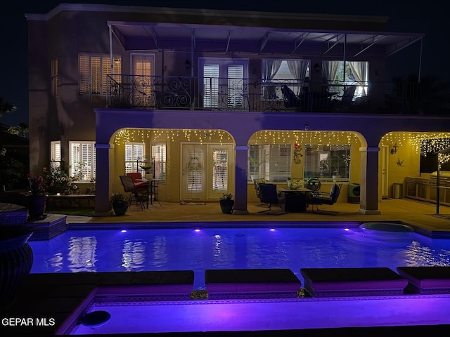 1337 Emerald Gate Ln, El Paso, TX 79936 - pool at twilight featuring a patio and a pool with connected hot tub