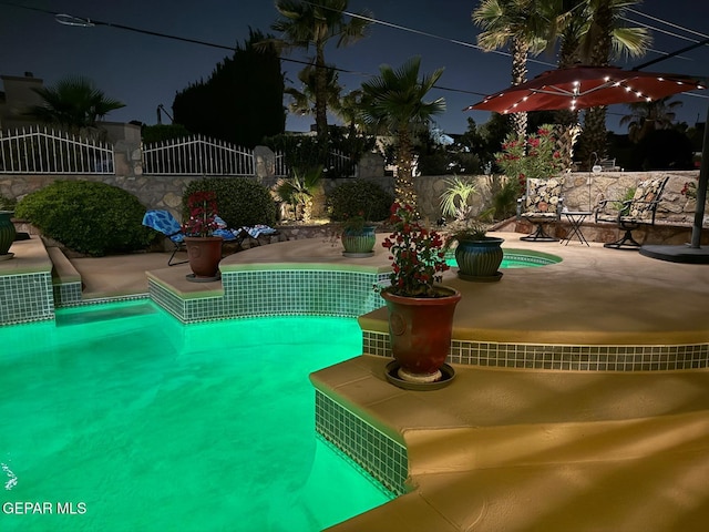 1337 Emerald Gate Ln, El Paso, TX 79936 - pool at twilight featuring a patio area and an outdoor pool