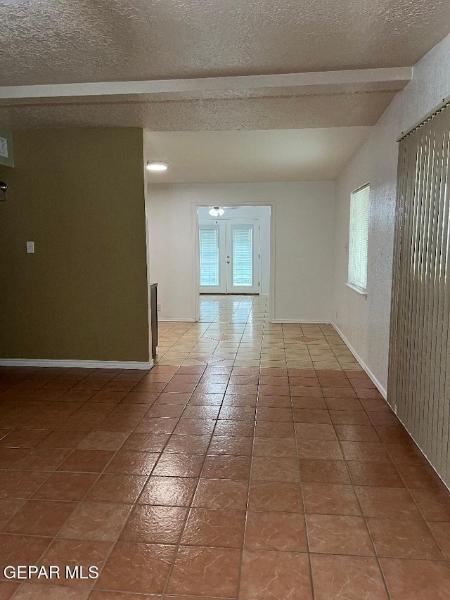 1017 Ralpheene St, El Paso, TX 79907 - spare room with a textured ceiling, tile patterned flooring, and vaulted ceiling