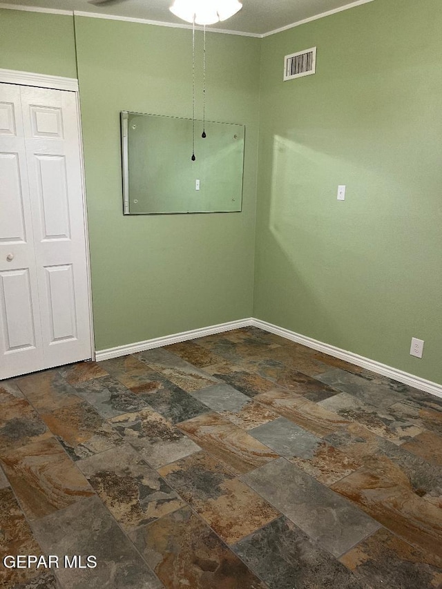 1017 Ralpheene St, El Paso, TX 79907 - unfurnished room featuring stone tile flooring, baseboards, and crown molding