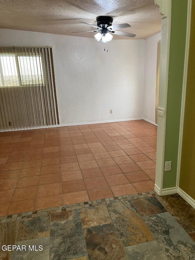1017 Ralpheene St, El Paso, TX 79907 - spare room featuring a ceiling fan, a textured ceiling, baseboards, and stone finish floors