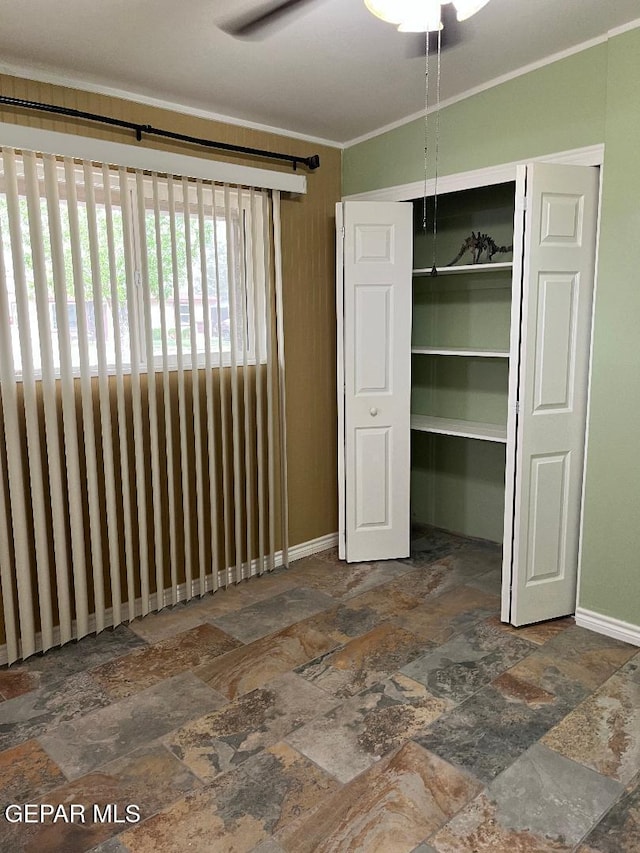 1017 Ralpheene St, El Paso, TX 79907 - unfurnished bedroom featuring stone tile flooring, baseboards, crown molding, and a closet