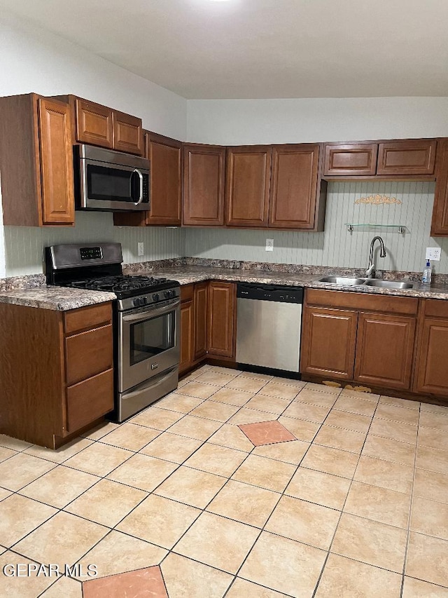 1017 Ralpheene St, El Paso, TX 79907 - kitchen with stainless steel appliances, a sink, and light tile patterned floors