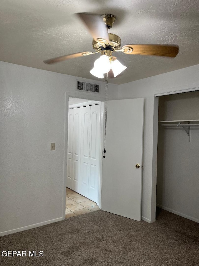 1017 Ralpheene St, El Paso, TX 79907 - unfurnished bedroom with light colored carpet, a closet, a ceiling fan, baseboards, and a textured ceiling