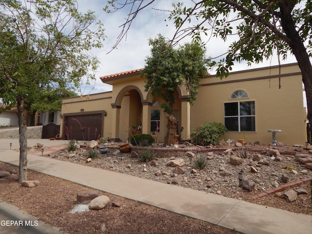 7012 Diamond Ridge Dr, El Paso, TX 79912 - mediterranean / spanish house featuring stucco siding and a garage