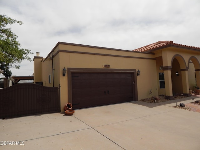 7012 Diamond Ridge Dr, El Paso, TX 79912 - view of front of house with a garage, concrete driveway, and stucco siding