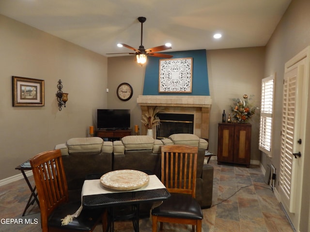 7012 Diamond Ridge Dr, El Paso, TX 79912 - dining area with stone tile flooring, a ceiling fan, recessed lighting, a fireplace, and baseboards