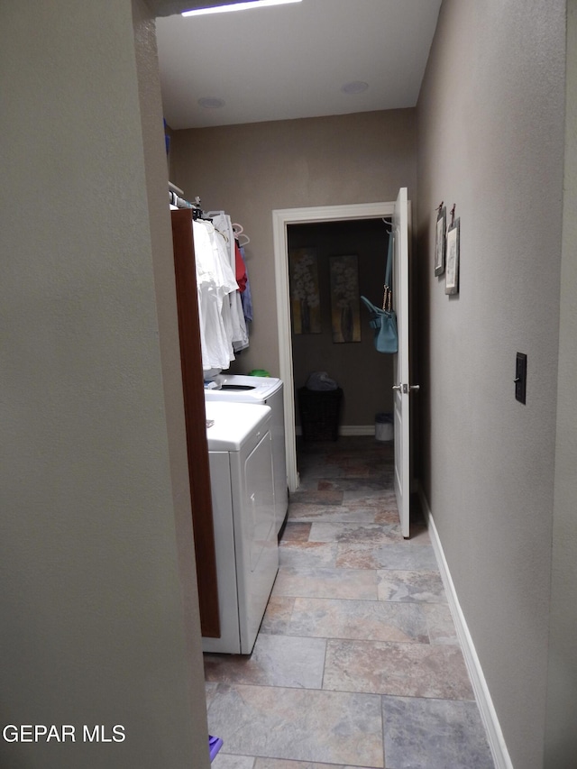 7012 Diamond Ridge Dr, El Paso, TX 79912 - washroom featuring washing machine and dryer, light stone finish flooring, and baseboards
