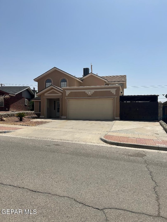 12014 El Greco Cir, El Paso, TX 79936 - view of front of house featuring an attached garage, stucco siding, and driveway