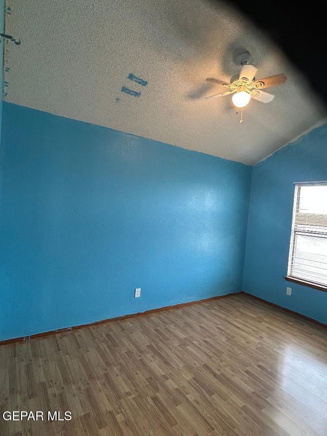 12014 El Greco Cir, El Paso, TX 79936 - empty room featuring lofted ceiling, wood finished floors, ceiling fan, a textured ceiling, and baseboards