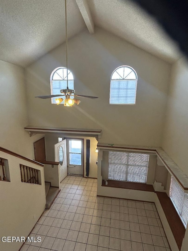 12014 El Greco Cir, El Paso, TX 79936 - entryway with high vaulted ceiling, light tile patterned floors, ceiling fan, beamed ceiling, and a textured ceiling