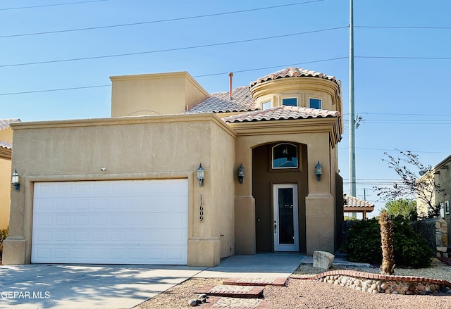 11609 Saint Thomas Way, El Paso, TX 79936 - view of front facade with stucco siding, a garage, a tile roof, and concrete driveway