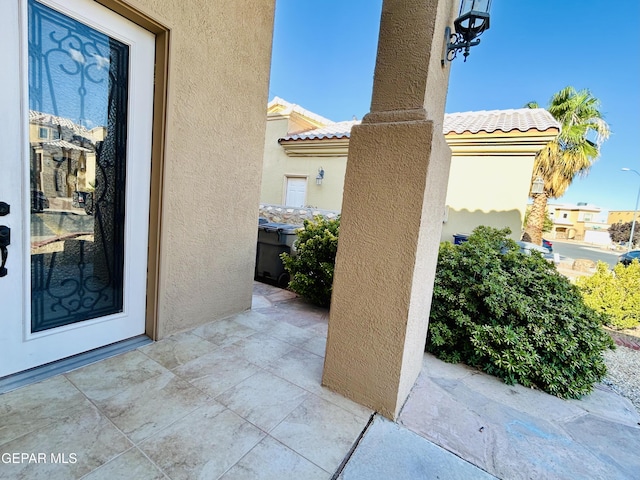11609 Saint Thomas Way, El Paso, TX 79936 - doorway to property with stucco siding, a patio area, and a tile roof