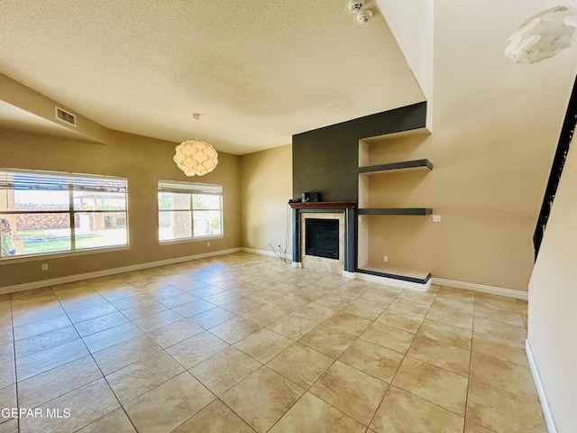 11609 Saint Thomas Way, El Paso, TX 79936 - unfurnished living room featuring a textured ceiling, baseboards, light tile patterned floors, and a fireplace