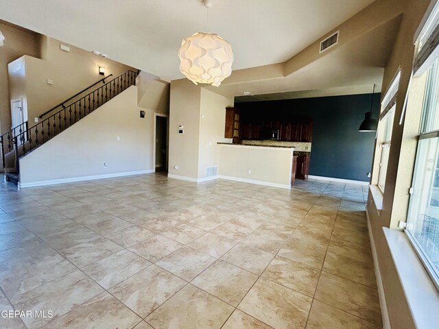 11609 Saint Thomas Way, El Paso, TX 79936 - unfurnished living room featuring a chandelier, light tile patterned flooring, baseboards, and stairway